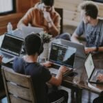 group of people using laptop computer